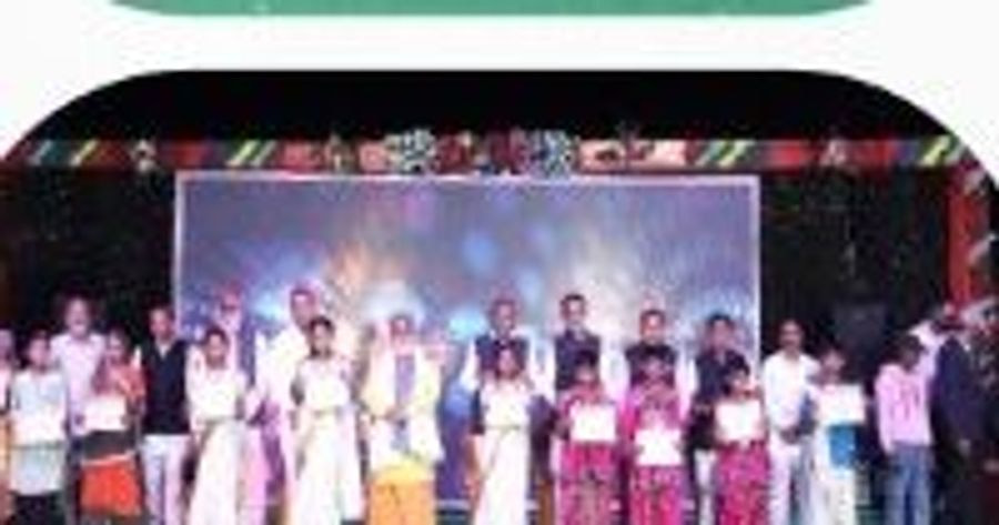 A large group of students standing together on stage at the annual celebration