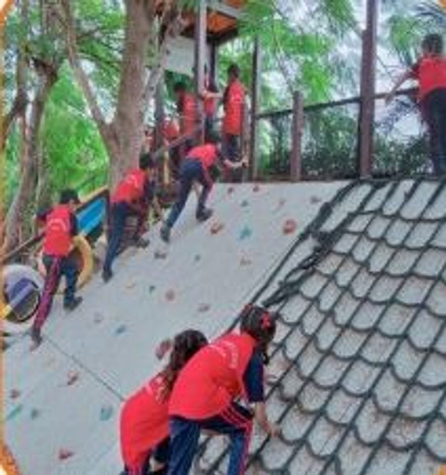 Children climbing an outdoor obstacle structure during a sports activity