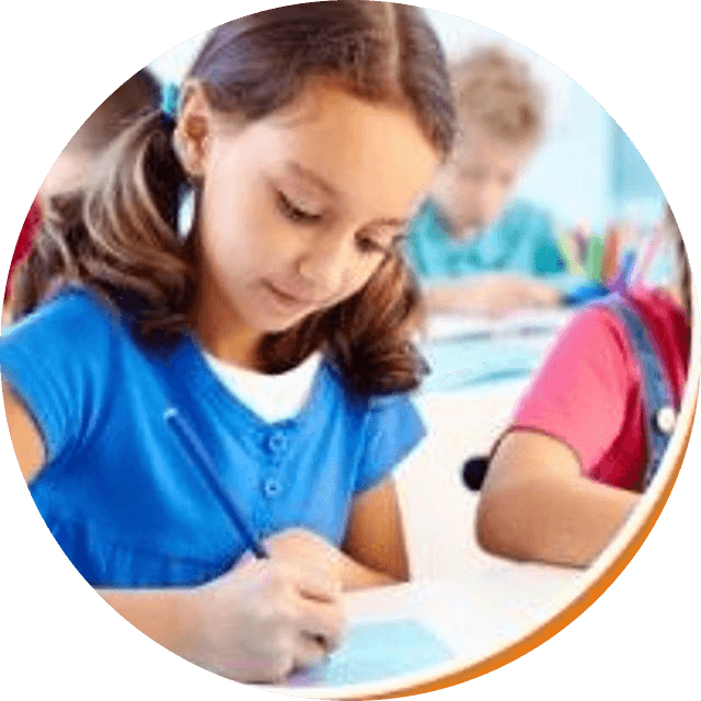 A pupil concentrating as she writes in her notebook during a class activity