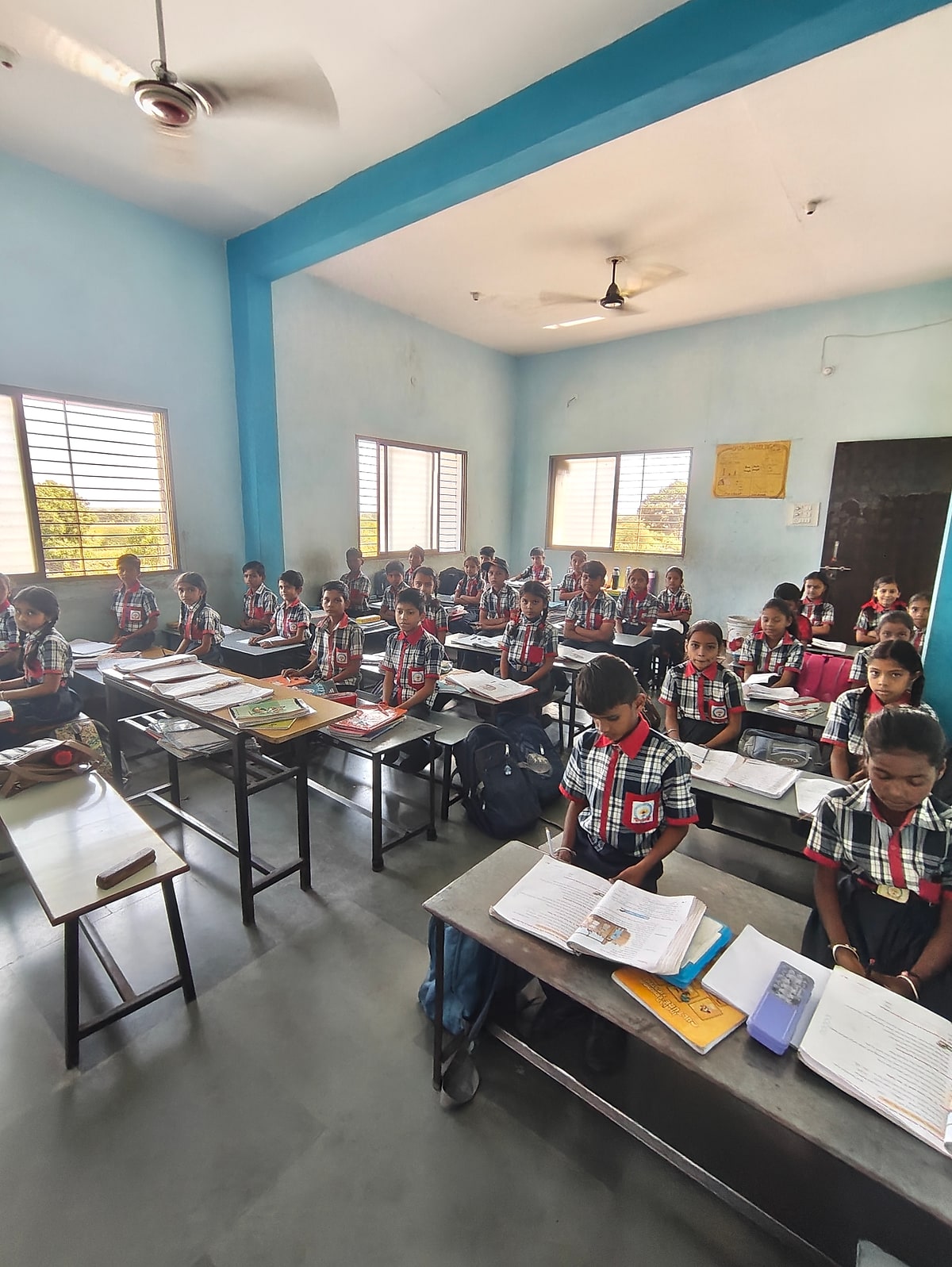 Pupils seated at their desks in a light, airy classroom at Sunrise Convent School, Bhensola